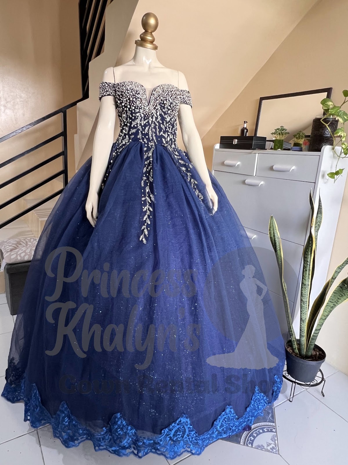 Royal blue off-shoulder ball gown with silver beadwork and lace hem detailing