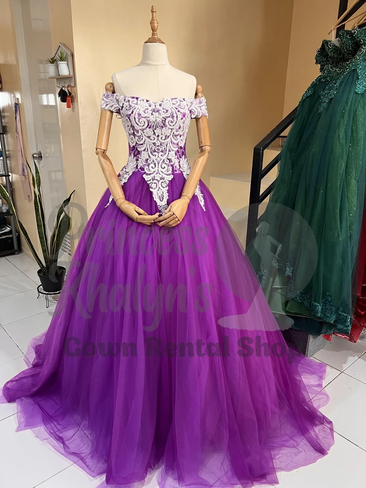 Purple off-shoulder ball gown with white baroque-style embroidery on the bodice and a voluminous tulle skirt