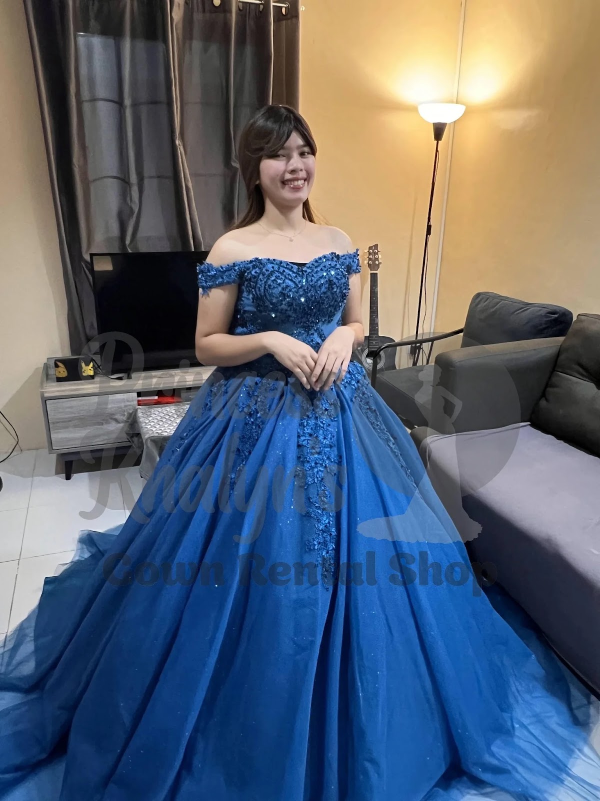 Royal blue off-shoulder ball gown with intricate sequin beadwork and 3D floral appliqué on the bodice and skirt