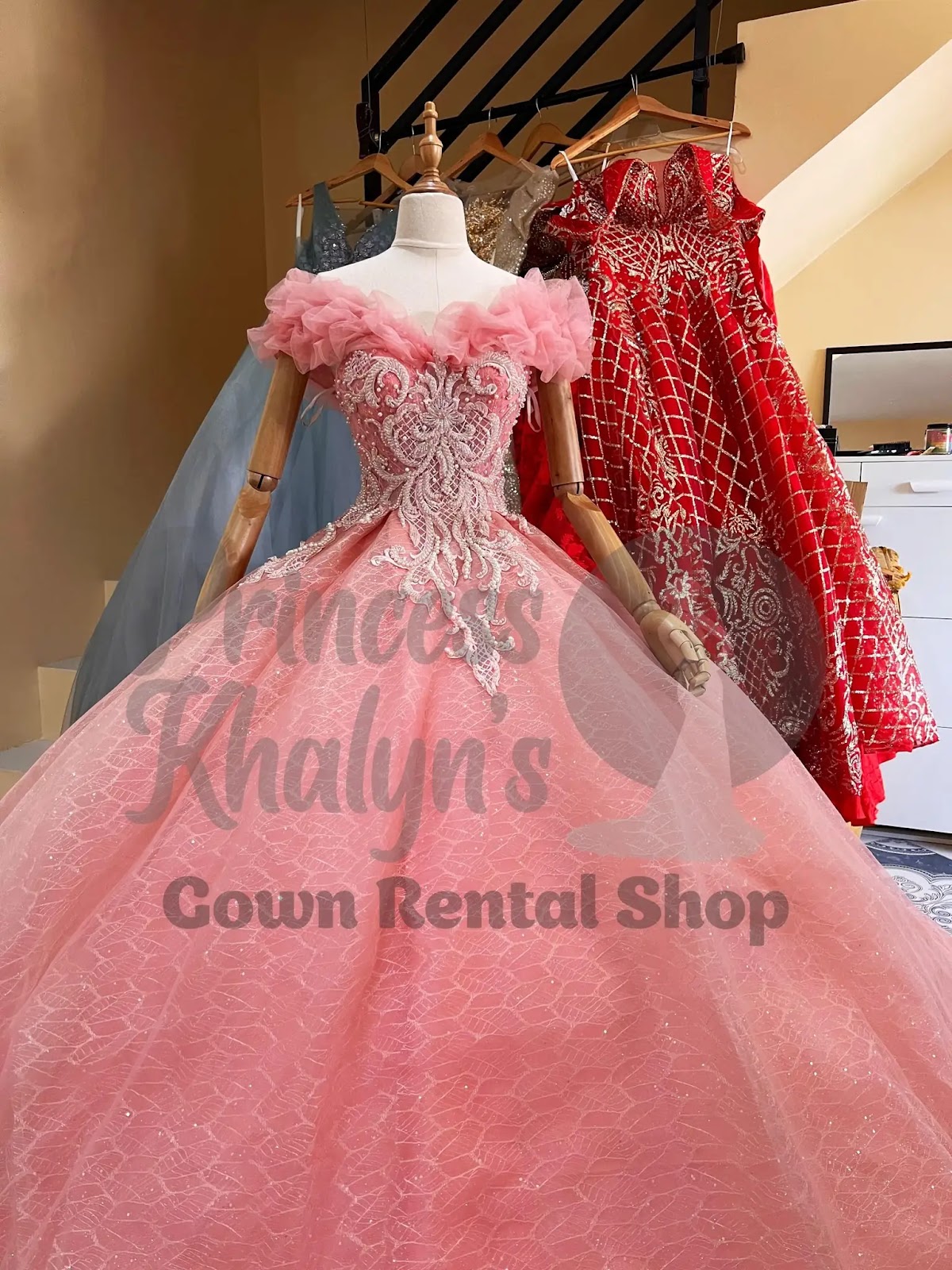 Coral pink off-shoulder ball gown with ruffled sleeves, intricate bead embroidery, and a shimmering textured skirt