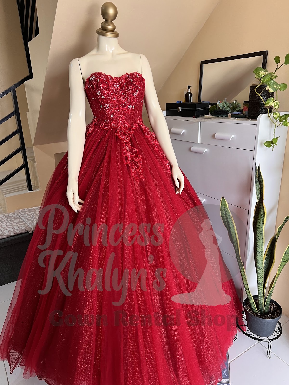 Strapless red ball gown with glittery tulle skirt and intricate floral embroidery with bead accents on the bodice