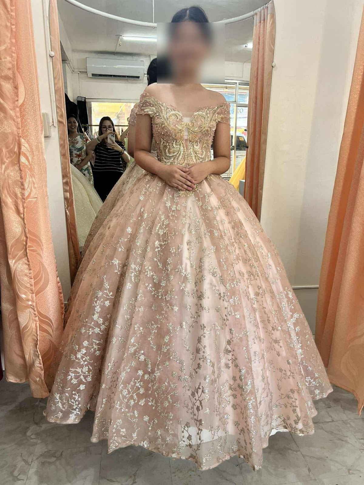 A stunning pink gown with an intricately beaded bodice and a flowing skirt adorned with delicate gold floral embroidery.