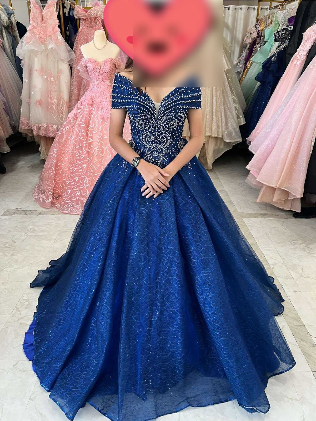 A stunning blue ball gown featuring intricate beadwork on the bodice and a voluminous layered skirt, perfect for formal occasions.