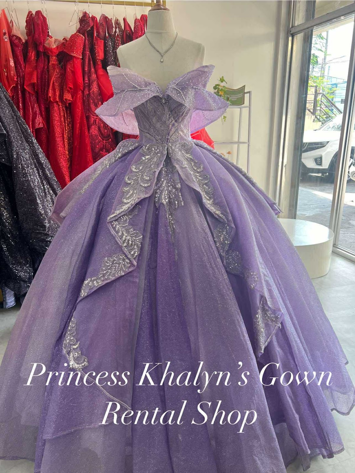 A stunning lavender gown featuring a dramatic layered skirt and intricate silver detailing, perfect for formal occasions.