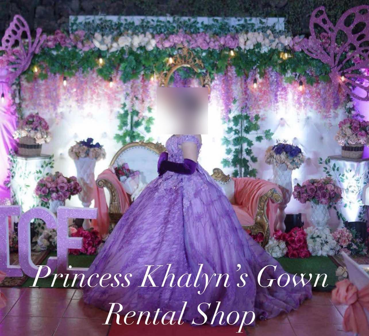 A stunning lavender gown featuring intricate floral detailing and a voluminous skirt, perfect for making a grand entrance at any special occasion.