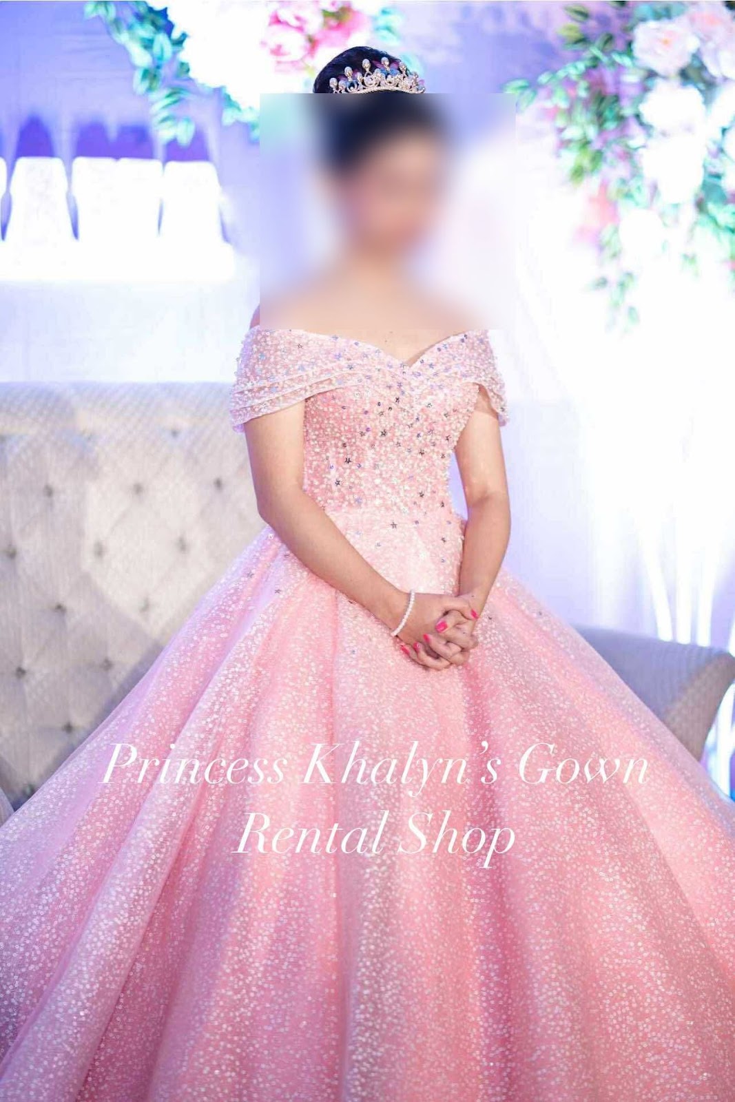 A stunning pink ball gown featuring an off-shoulder design adorned with sparkling embellishments, perfect for celebrating special occasions.