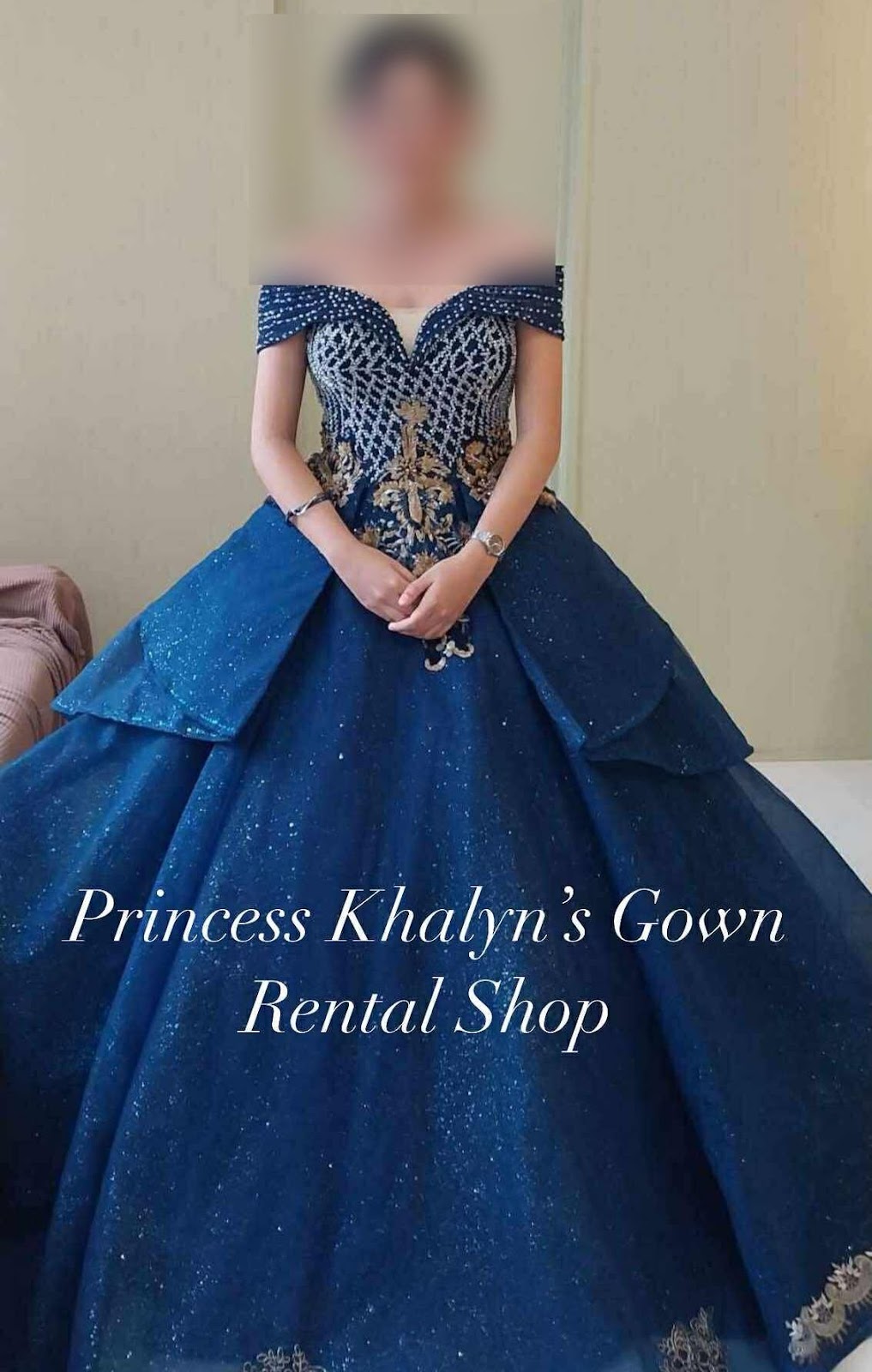 A stunning navy gown featuring intricate beading and a dramatic layered skirt, perfect for creating a regal appearance at any formal event.