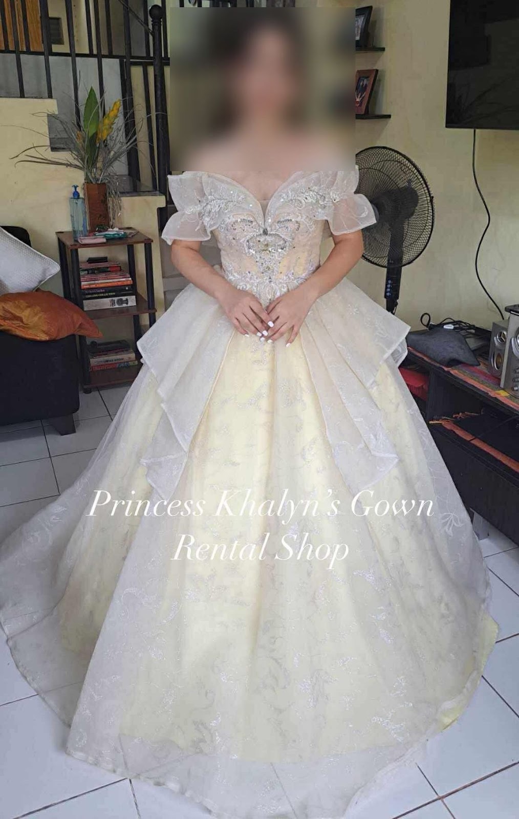 A stunning gold gown featuring intricate beadwork and a layered tulle overlay, designed for a regal appearance at formal events.